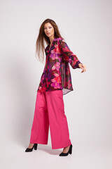 Young asian woman in blouse and pink pants.