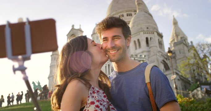 Traveling couple taking loving selfie abroad having fun at tourist attractions. In love, smiling and romantic partners post travel pictures on holiday. Happy tourists on vacation enjoying their trip
