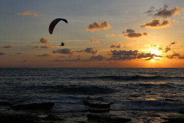 Paragliding in the sky over the Mediterranean Sea.