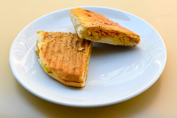 Turkish toast, mixed toast with cheddar cheese, sausage and ham, with fried potatoes (Turkish name; Bazlama Karisik tost)