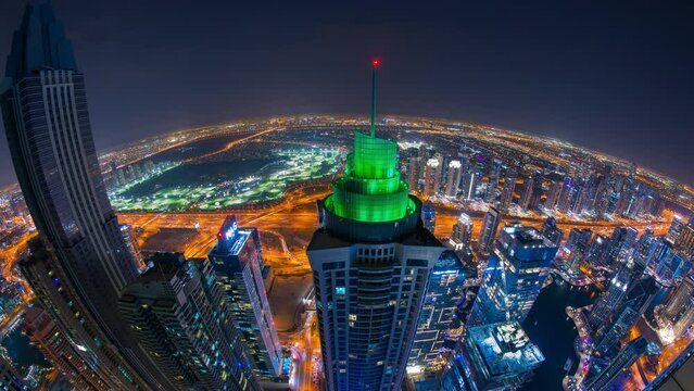 night Time lapse of  Dubai city high rise building  in Dubai Marina, with traffic sheik zayed road and marina bay from top view.