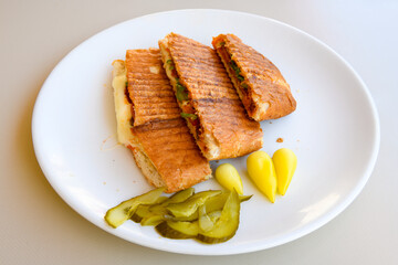 Turkish toast, mixed toast with cheddar cheese, sausage and ham, with fried potatoes (Turkish name; Bazlama Karisik tost)