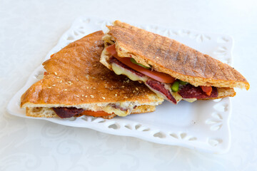 Turkish toast, mixed toast with cheddar cheese, sausage and ham, with fried potatoes (Turkish name; Bazlama Karisik tost)