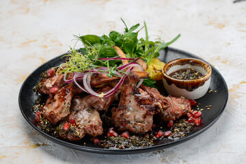 fried meat loin in a plate with greens and grilled pineapple
