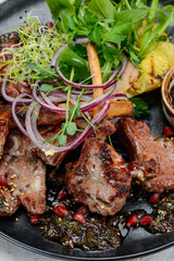 grilled meat square in a plate with greens and pineapple grill vertical macro photo
