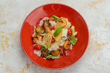 salad with seafood in a red plate
