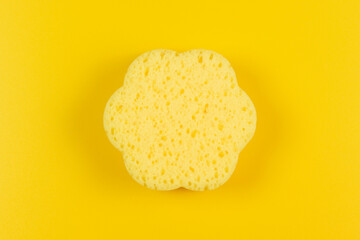 Cleaning sponge on a yellow background.