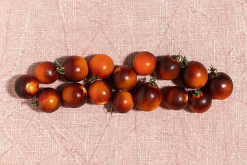 Black strawberry tomatoes on the table. Top view.