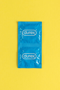 Durex condoms on yellow background.