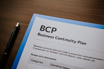 There is dummy documents that created for the photo shoot on the desk about Business Continuity Plan.