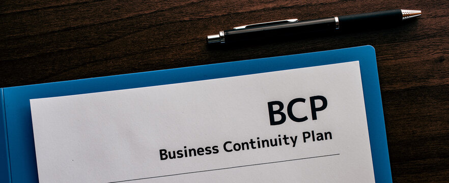 There is dummy documents that created for the photo shoot on the desk about Business Continuity Plan.