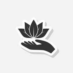 Lotus in hand sticker icon isolated on white