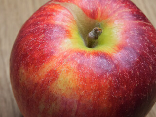 A  single large ripe gala apple, a close-up shot. Beautiful fruit.