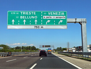 Motorway junction with sign with directions to major cities in Italian such as Venice and the airport