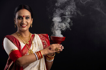 Portrait of Bengali woman holding a dhunuchi