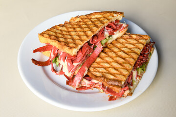 Turkish toast, mixed toast with cheddar cheese, sausage and ham, with fried potatoes (Turkish name; Bazlama Karisik tost)