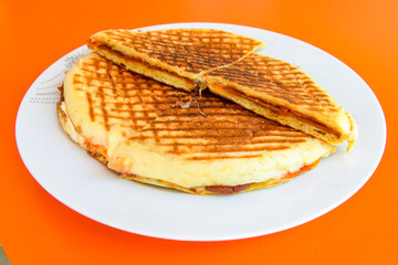 Turkish toast, mixed toast with cheddar cheese, sausage and ham, with fried potatoes (Turkish name; Bazlama Karisik tost)
