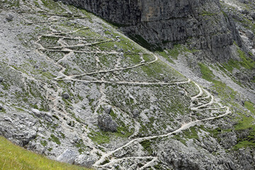 serpentine path in the Alps mountains with a zigzag pattern and back turns