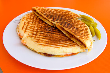 Turkish toast, mixed toast with cheddar cheese, sausage and ham, with fried potatoes (Turkish name; Bazlama Karisik tost)