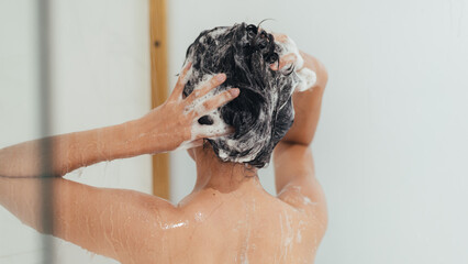Naklejka premium Woman Washing Hair with Shampoo and Shower in Bathroom, Asian female body and Hair Care with Foam to freshness. Spa and Health care.