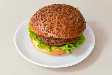 Big tasty burger with beef cutlet on a plate