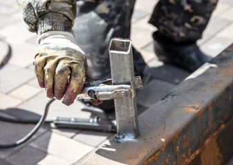 A worker works with metal at a construction site.