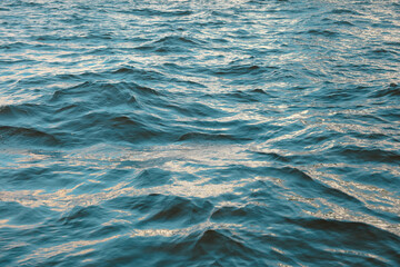 Fototapeta premium Wavy surface of water in a reservoir as an abstract background.
