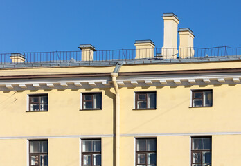 Windows on the wall of an old high-rise building.
