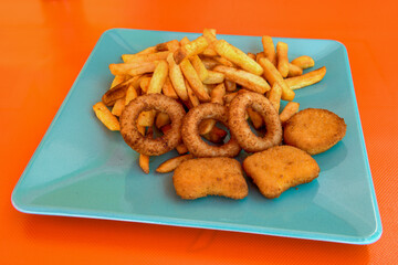 Fried Chicken breast hot crispy strips crunchy chicken tenders  isolated on white background.Nuggets isolated on white background on a plate