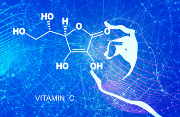 Hand holding chemical molecular formula of vitamin C ascorbic acid.