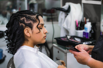 Young woman getting makeup and hair done in a professional spa or hair salon.