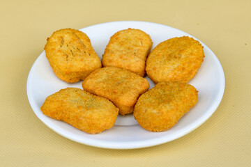 Fried Chicken breast hot crispy strips crunchy chicken tenders  isolated on white background.Nuggets isolated on white background on a plate