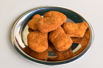 Fried Chicken breast hot crispy strips crunchy chicken tenders  isolated on white background.Nuggets isolated on white background on a plate