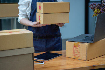 Online sales woman business owner Receive orders and deliver products with boxes to customers. Online SME business concept.