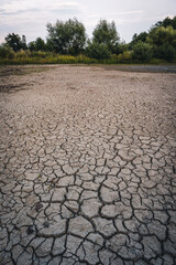 Dry lake in Bavaria Germany. Drought and climate change, landscape of cracked earth after lake has...
