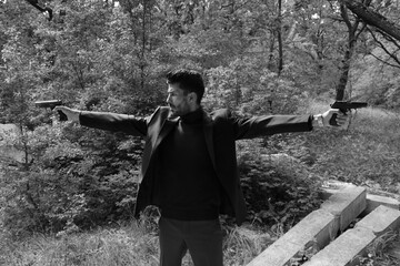 A man with two guns in black and white