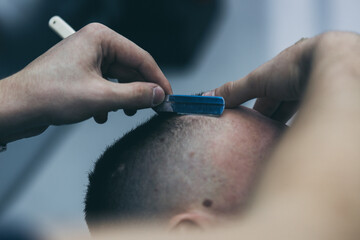 Barbershop haircut styling with dangerous blade