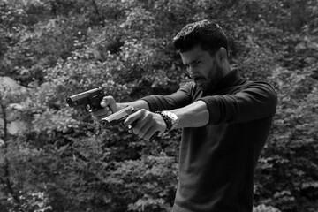 A man with two guns in black and white