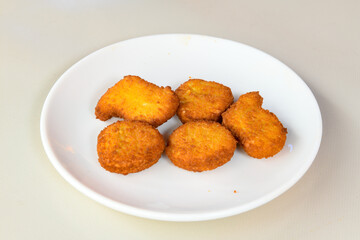 Fried Chicken breast hot crispy strips crunchy chicken tenders  isolated on white background.Nuggets isolated on white background on a plate