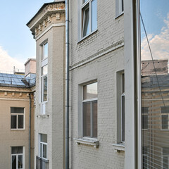 Obraz premium View of neighboring houses city life from an open window.