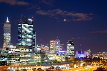 Beautiful image of full moon and Lunar Eclipse over Perth city, Western Australia - obrazy, fototapety, plakaty
