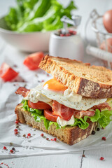 Homemade and crunchy toasted sandwich with bacon, mayonnaise and egg.