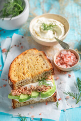 Homemade and tasty sandwich with avocado, salmon and dill.