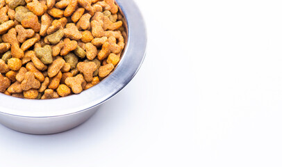 A close-up of part of a metal bowl with dry food for animals, cats and dogs