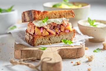 Tasty and fresh sandwich with exotic fruits, chicken and herbs.