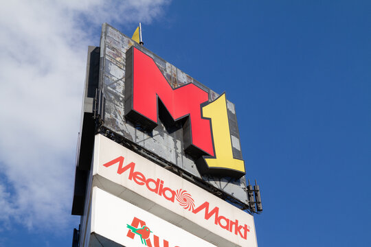 M1 Kraków mall logo. Indoor shopping center large signboard, with brand logotypes of Media Markt and Auchan stores on June 1, 2022 in Krakow, Poland.