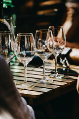 wine that is poured into glasses in the rays of the setting sun