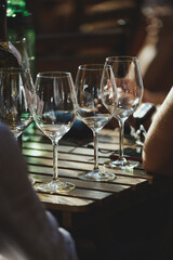 wine that is poured into glasses in the rays of the setting sun