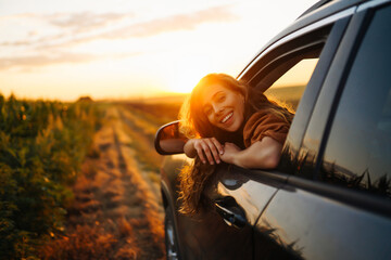 Towards adventure! Young woman is resting and enjoying the trip in the car.  Lifestyle, travel, tourism, nature, active life. © maxbelchenko