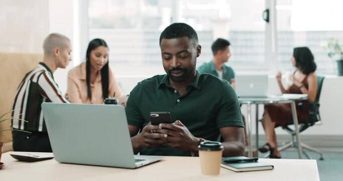Texting on a phone, browsing social media on a laptop and feeling excited about new job opportunity in creative office. Laughing, smiling and happy marketing agent working on startup website at lunch